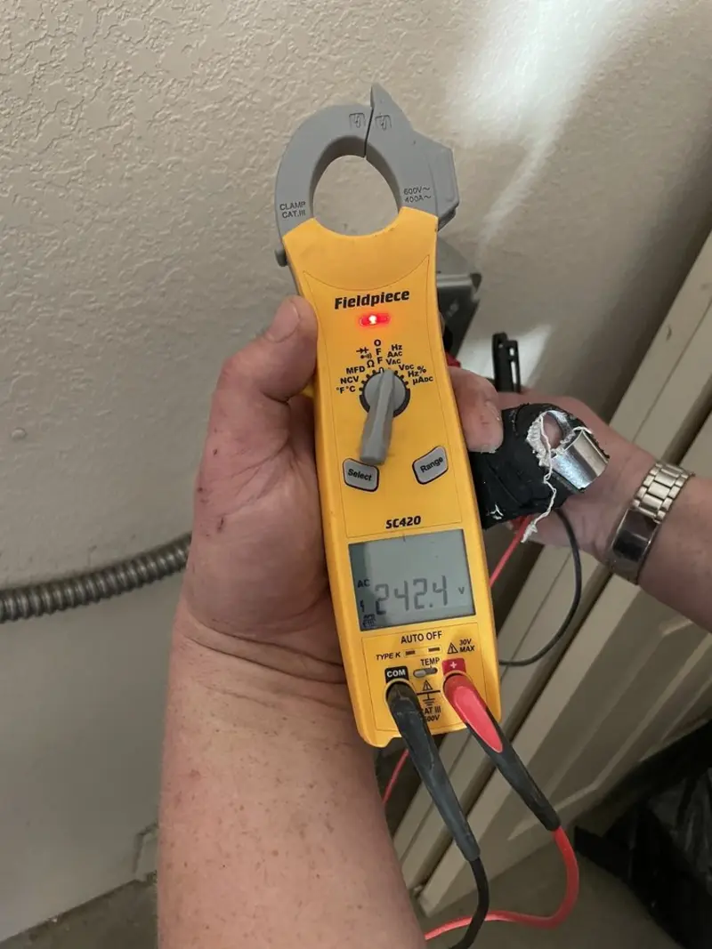 Voltage testing with clamp meter during Electrical Installation Services in California